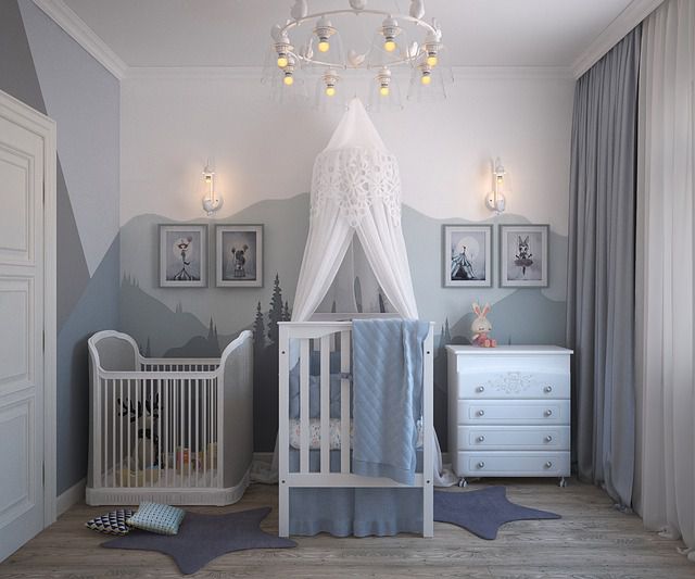 A white and grey room with a small bed and furniture for toddlers, as an example of how to redecorate your kid’s room.