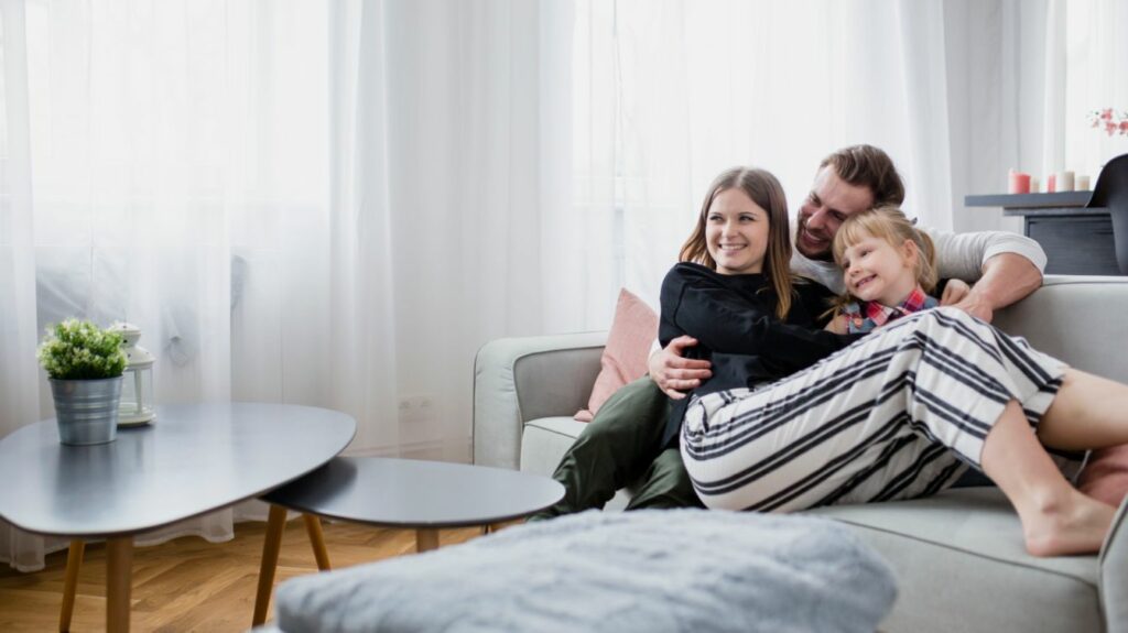 Family laughing in the living room.