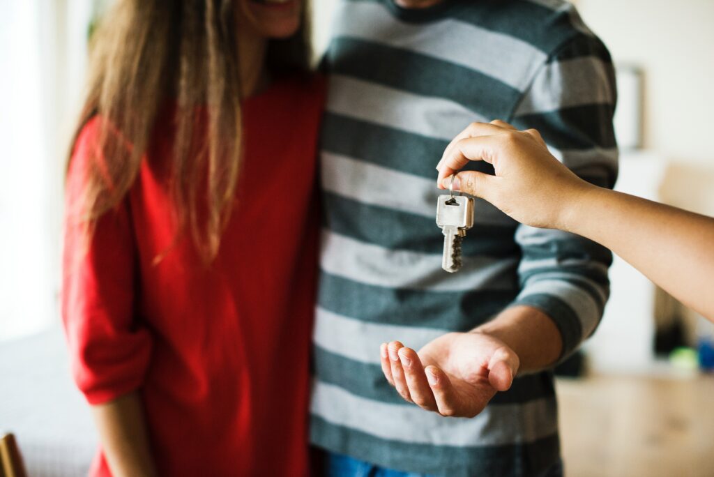 A person gives keys to a man after buying an apartment in NYC.