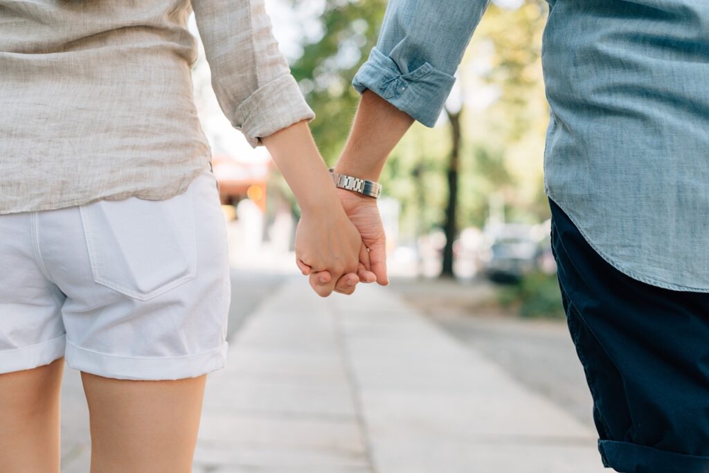 a couple holding hands trying to make a long distance relationship last