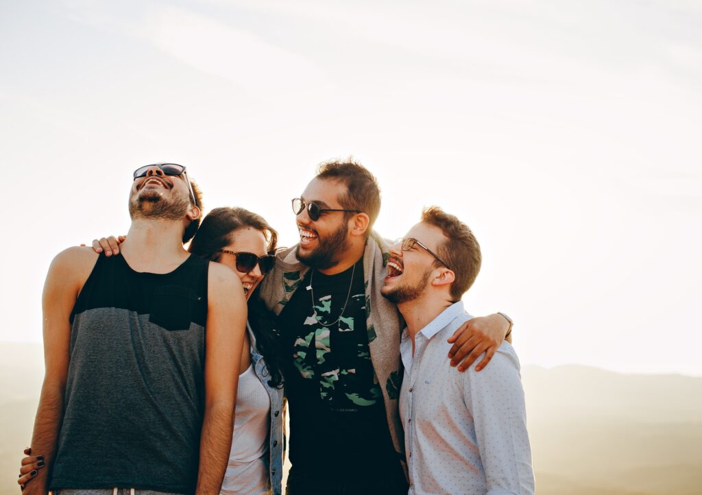 men laughing friends white shirt