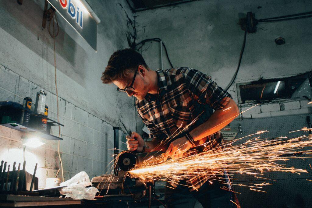 A man welding iron signifying that there are some things that you can DIY.