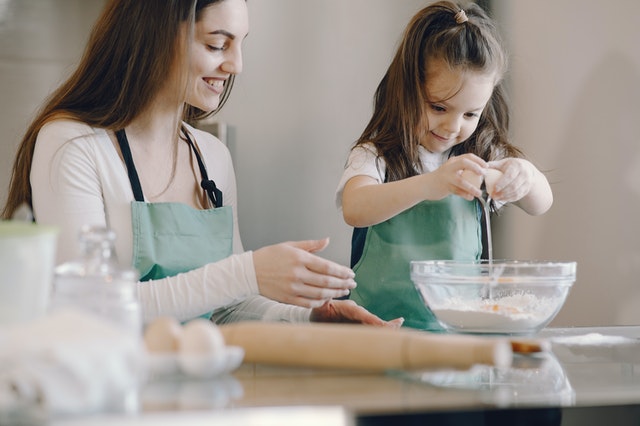 Mother and daughter making cookies