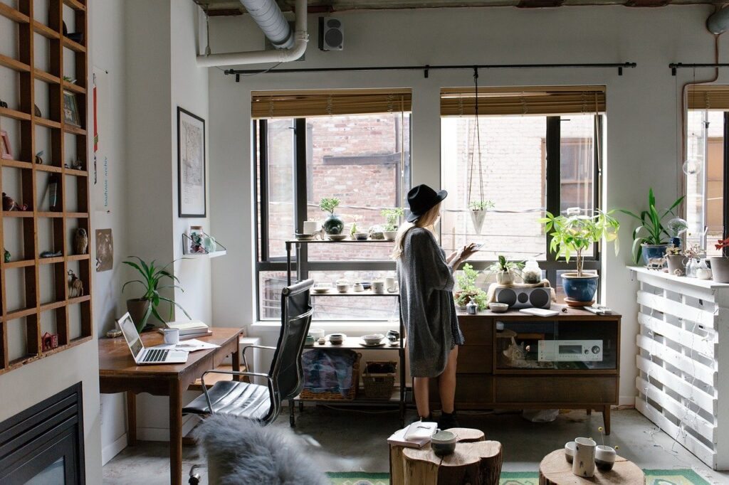 A girl standing in her home office, giving you an idea of what setting up a home office during COVID-19 can look like.