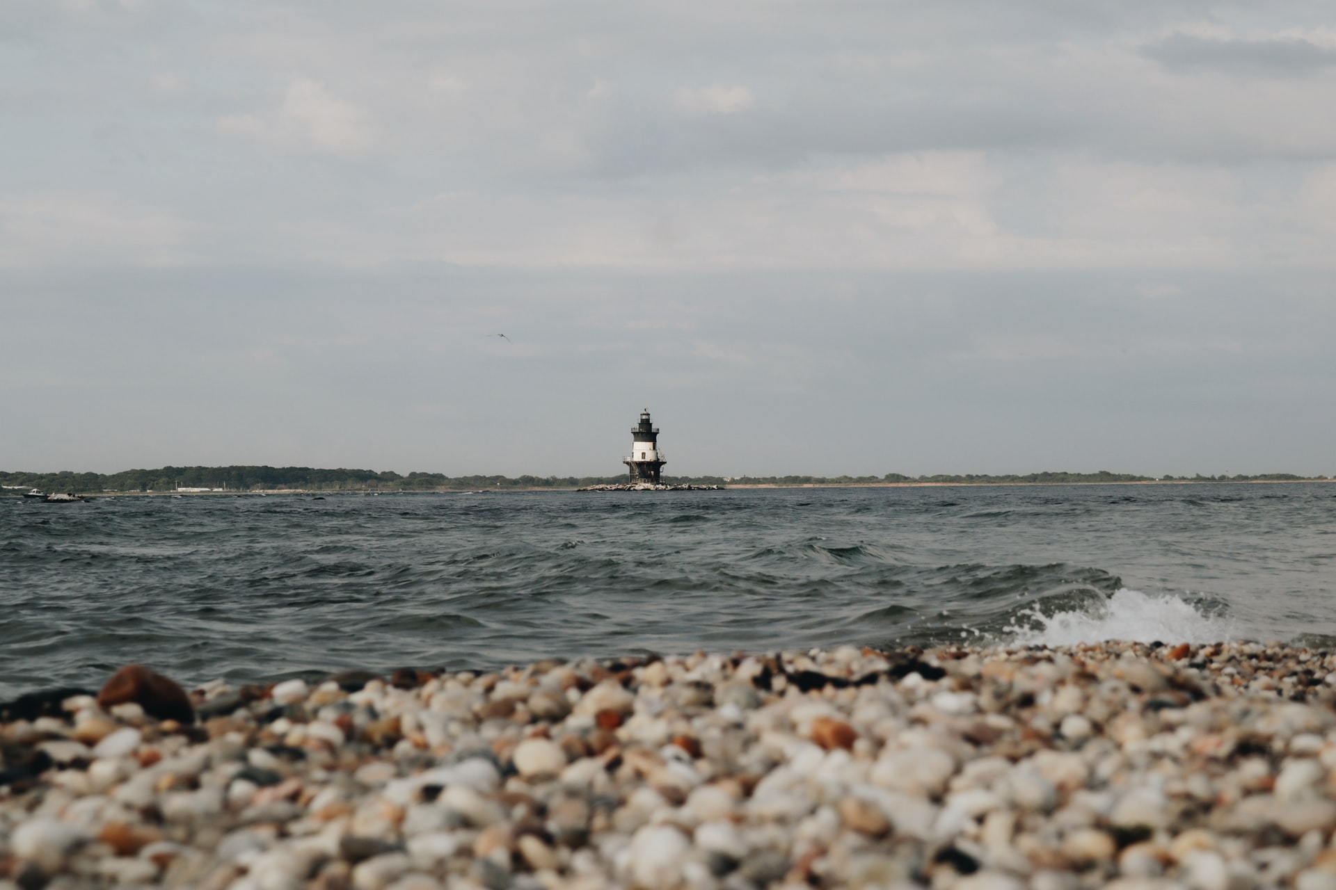 pebble beach with a lighthouse