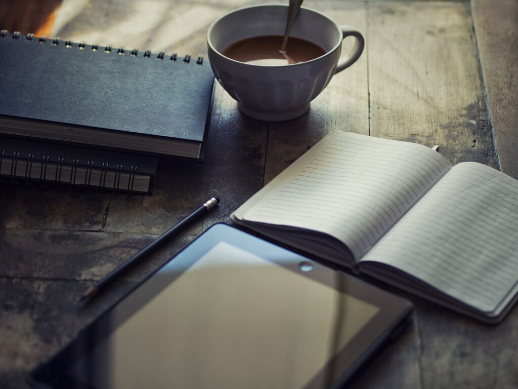 blogger work with book ad notebooks with a cup of coffee