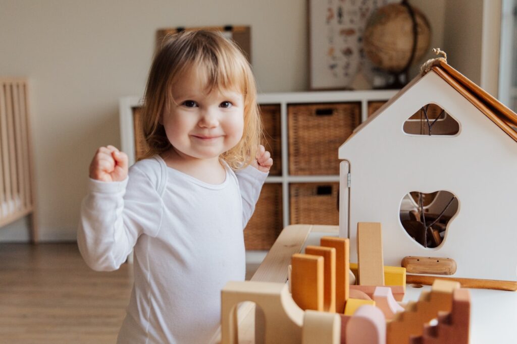 A baby girl playing with toys.