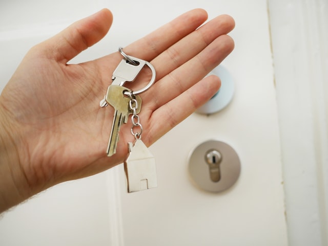 a person holding a house key