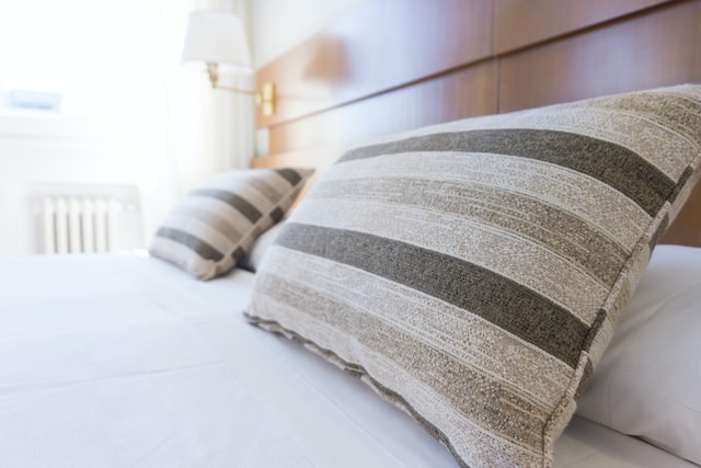 a bed in a clean home shows that cleaning and organizing can be therapeutic.