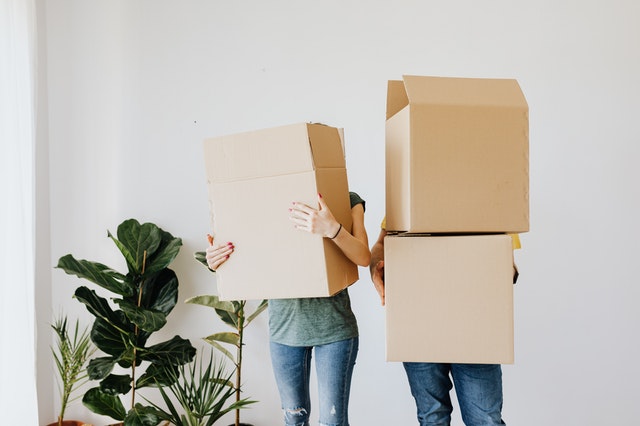 A couple holding boxes