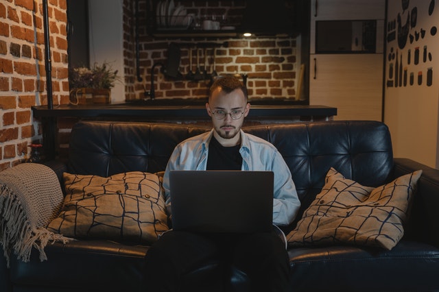 a person using a laptop on a couch