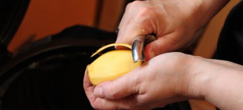 Man peeling a potato 