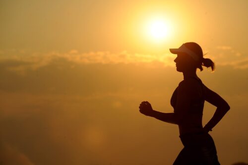 a woman running at dawn