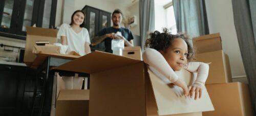 A family is packing their possessions in boxes for a relocation.