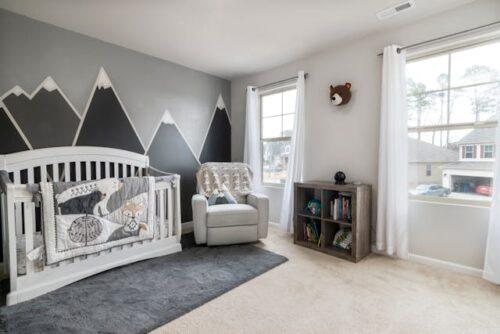 A cozy nursery room with a gray-and-white theme.