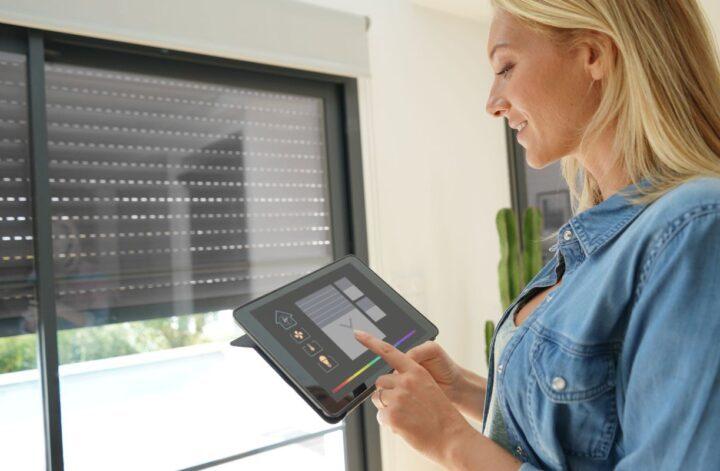woman closing blinds