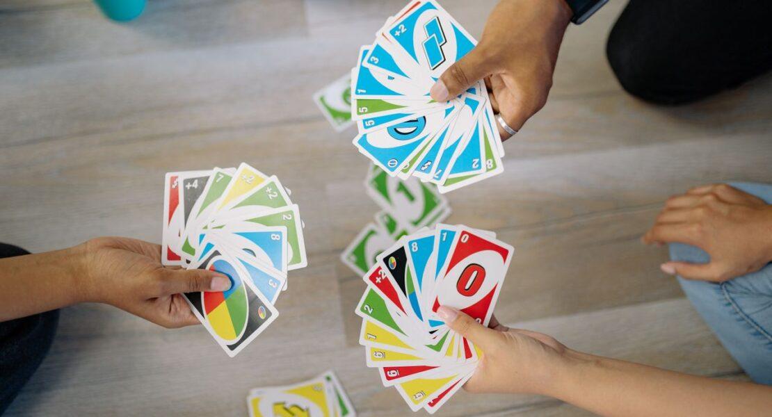 Family members playing a card game together, highlighting meaningful interaction and quality time with teenagers.