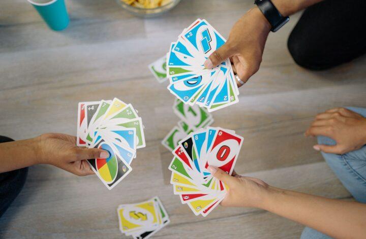Family members playing a card game together, highlighting meaningful interaction and quality time with teenagers.