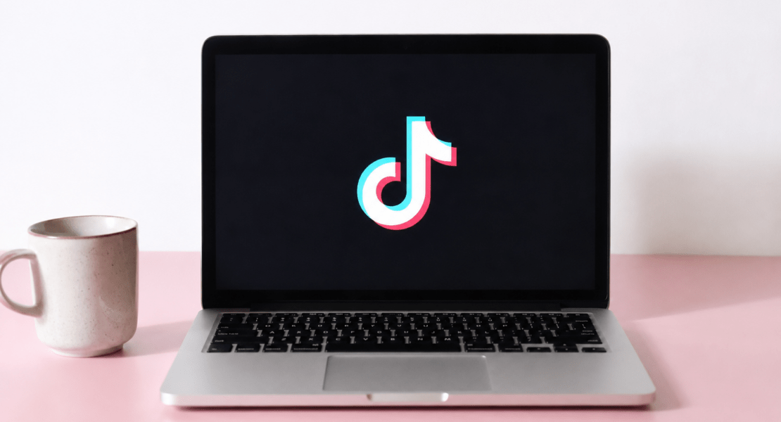 Laptop displaying the TikTok logo on screen, illustrating TikTok AI content policy updates that prioritize human creators.