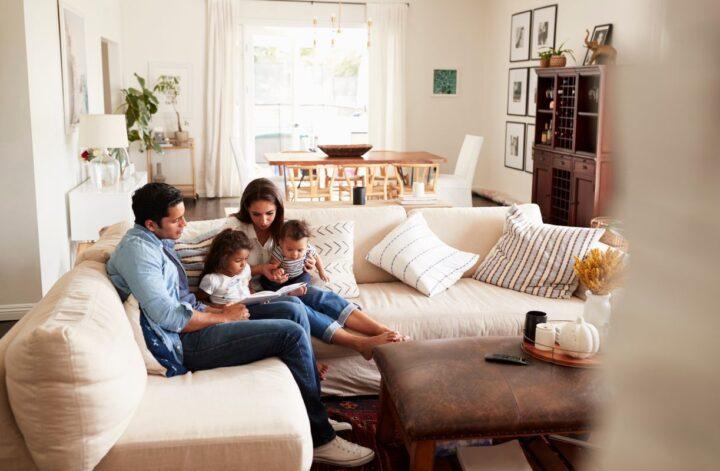 Family relaxing together in a stylish living room designed for family home safety.